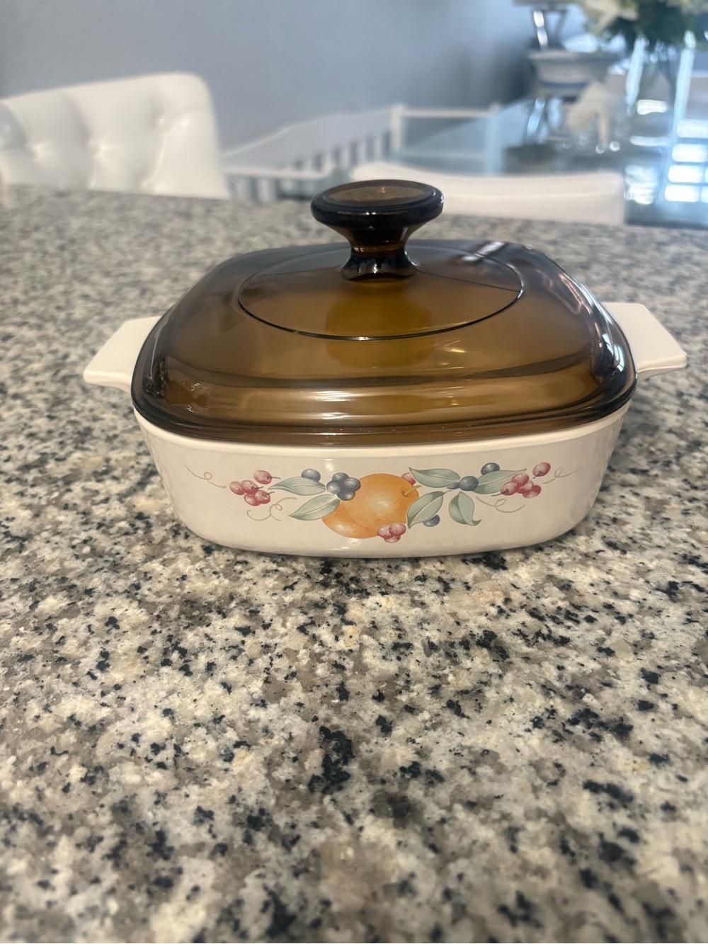 A vintage Corning Ware Abundance pattern casserole with Fruit Motif - Cream